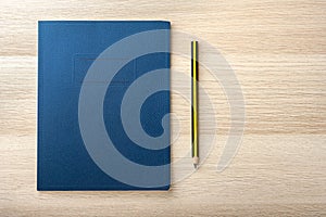 Notepad on wooden desk with pencil