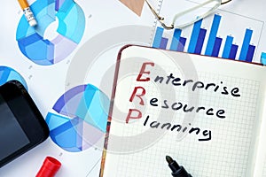 Notepad with word ERP enterprise resource planning concept.
