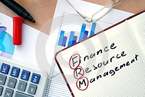 Notepad with word FRM finance resource management concept.