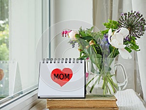 Notepad with the word MOM. Greeting card