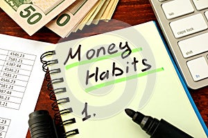 Notepad with word Money Habits. Saving and planning.