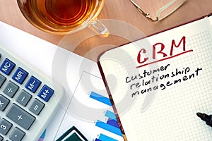 Notepad with words CRM customer relationship management concept.