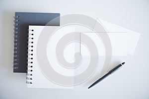 Notepads, converts and pen on the table