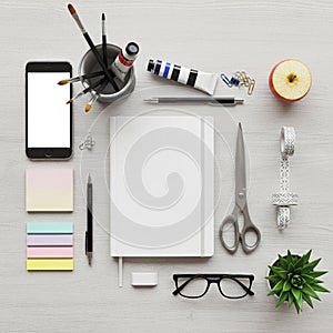 Notes are nearby. A smartphone with a blank screen is on the