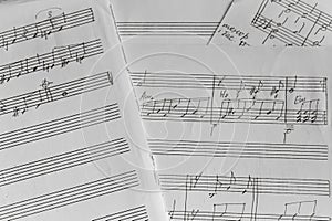 Notes on paper, monochrome. Old music sheet, black and white. Melody on page. Notes and lines. Music concept. Musical education.