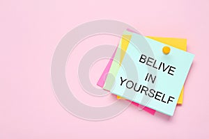 Notes with phrase Believe In Yourself and space for text on pale pink background, top view. Motivational quote