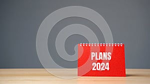 Notes with words Plans 2024. Planning goals and tasks. New business ideas. Setting goal, target. Motivation and strategy. Copy