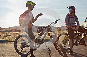 Nothing beats a bike ride. two young male athletes mountain biking in the wilderness.