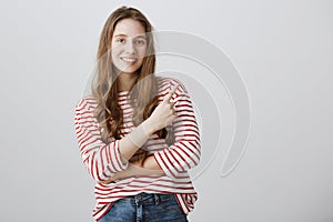 Nothing can be cool than this copy space. Indoor portrait of friendly attractive female student pointing at upper right