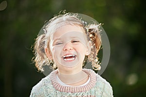 Nothing compares to little giggles. an adorable little girl playing outside.