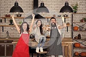 Nothing but family. relatives having fun while cooking. Mother and father teaching daughter how to cook. small girl with