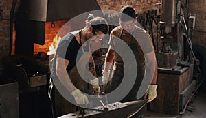 Nothing is impossible in our workshop. two metal workers working together in a workshop.