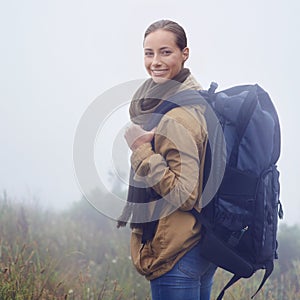 Nothing like a good hike to make you feel alive. Portrait of an attractive young woman out hiking on an overcast day.
