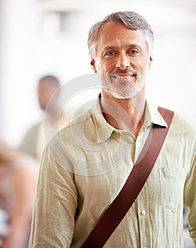 Nothing recedes like success. Portrait of a mature businessman with his colleagues blurred in the background.