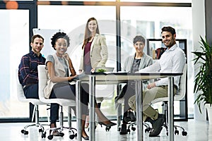 Nothing stands in our way of achieving excellence. Portrait of a group of businesspeople having a meeting together in a