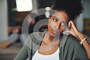 Nothing will ever be the same again. an attractive young woman looking upset while her boyfriend sits in the background