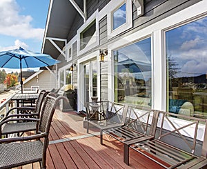 Nothwest traditional wooden deck with chairs and windows.