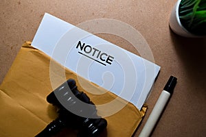 Notice in brown envelope and judges gavel. Justice and Law Concept