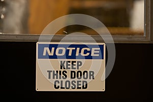 NOTICE, KEEP DOOR CLOSED, door sign