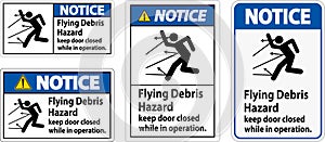 Notice sign indicating the risk of flying debris, advising to keep the door closed