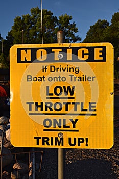 Notice sign to use low throttle when loading a boat on a trailer