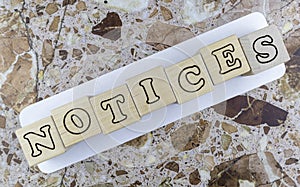 Notices concept with alphabet letters on wooden cubes photo