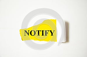 Notify word written on yellow paper and white background