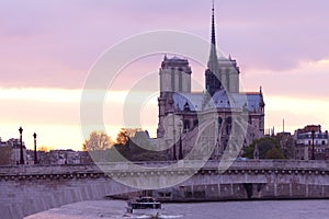 Notre Dame Cathedral on Ile de la Cite and Pont de la Tournelle over Seine river in Paris