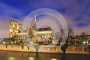 Notre-Dame Cathedral and river Seine at night in Paris