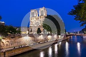 Notre-Dame de Paris Cathedral and Cite island embankment at night, France