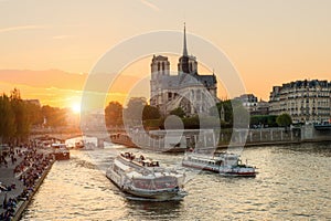 Notre Dame de Paris cathedral with cruise ship in Seine river
