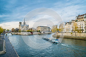 Notre-dame-de-Paris, the Seine river and a boat photo