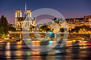 Notre Dame de Paris, Seine River and the Sully Bridge at twilight. France