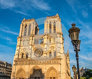 Notre-Dame de Paris in sunset during summer with street lamp