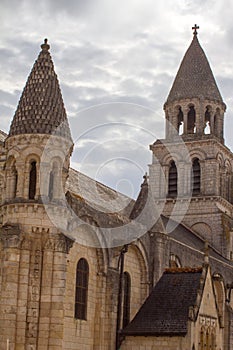 Notre Dame-La-Grande, Roman church over beautiful grey sky, France