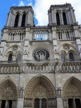 Notre Dame of Paris. Facade detail and tower against a blue sky