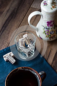 Nougat candy in a glass and tea, blue napkin