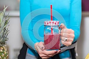 Nourishing and Refreshing: Woman Enjoying a Red Smoothie