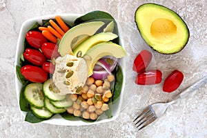 Nourishment bowl with avocado, hummus and mixed vegetables photo