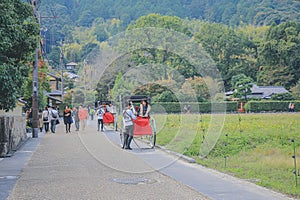 2 Nov 2013 Unidentified man with a rickshaw and tourists at Chikurin-no-michi