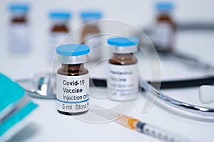 Novel coronavirus covid-19 vaccine vial with syringe and stethoscope photo