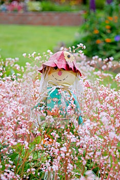 A novelty scarecrow garden ornament