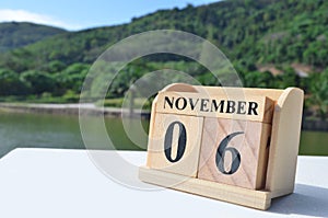 November 06, Date design with number cube on white table, cover design in the natural concept.