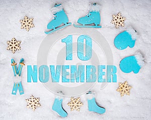 November 10th. Sports set with blue wooden skates, skis, sledges and snowflakes and a calendar date. Day 10 of month.