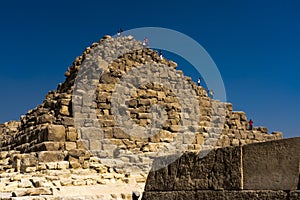 NOVEMBER 13, 2019, CAIRO, EGYPT - People climbing pyramid at The Great Pyramids of Giza, Cairo, Egypt