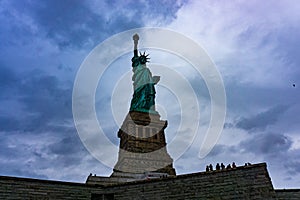 November 2018 - Statue of Liberty on light blue sky, landmark in New York City, USA, bottom view.