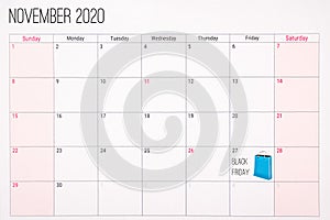 November 2020 calendar with black friday text and blue shoppin bag in friday 27th.