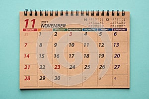 November 2021 desk calendar on green background