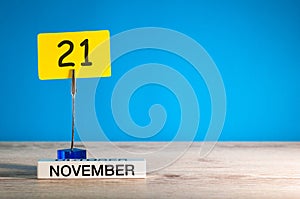 November 21st. Day 21 of november month, calendar on workplace with blue background. Autumn time. Empty space for text