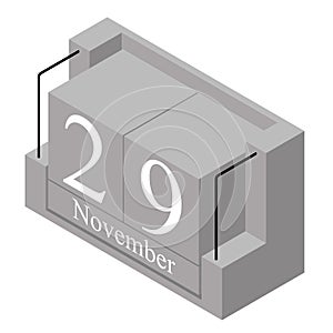 November 29th date on a single day calendar. Gray wood block calendar present date 29 and month November isolated on white